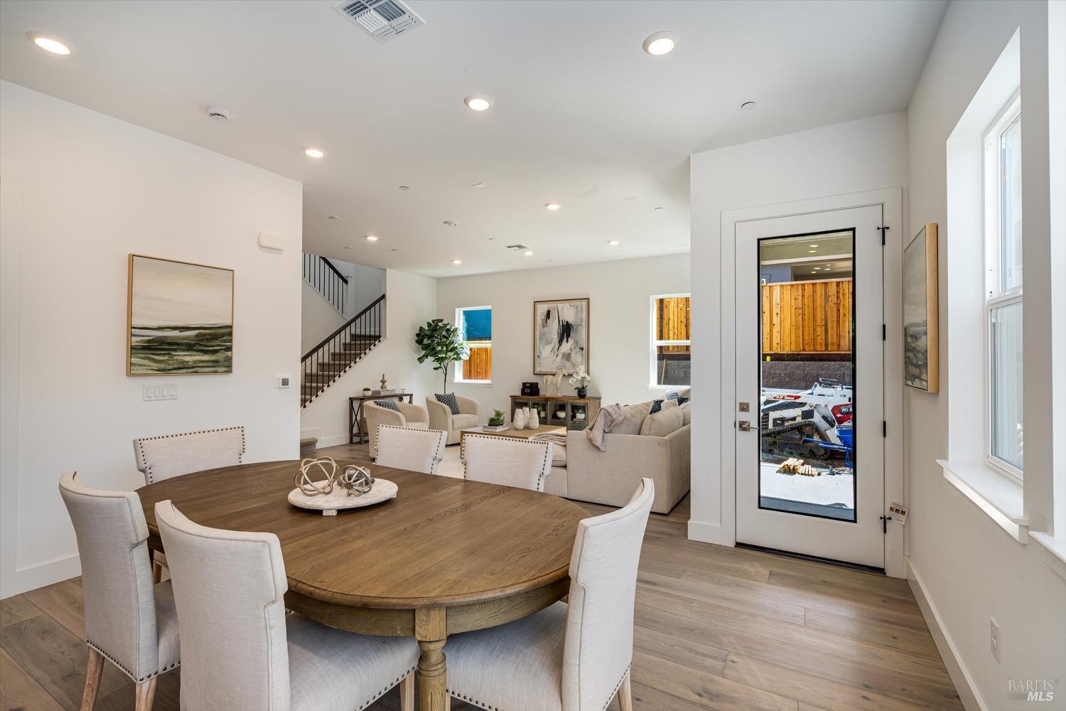 103 Grace Lane Napa, CA 94559 - Photo 22 of 39 a view of a dining room and livingroom with furniture wooden floor a chandelier