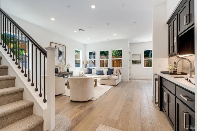 a view of living room kitchen with furniture and wooden floor