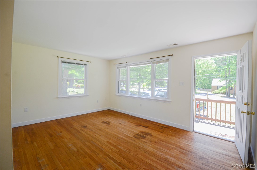 4100 Treely Road Chester, VA 23831 - Photo 9 of 29 a view of an empty room with wooden floor and a window