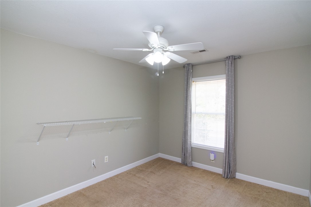735 Britton Street Anderson, SC 29621 - Photo 34 of 50 This cozy bedroom features a ceiling fan and natural light from a window, creating a comfortable ambiance.