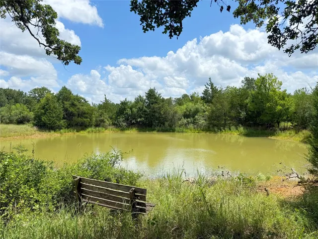 a view of a lake with a yard and lake view