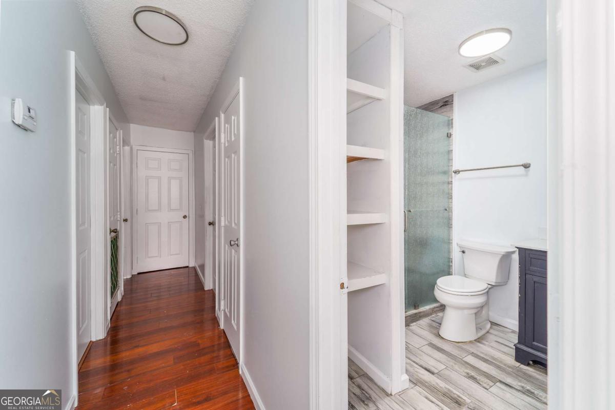 301 Ridge Lane Douglas, GA 31533 - Photo 14 of 26 a bathroom with a toilet and a shower