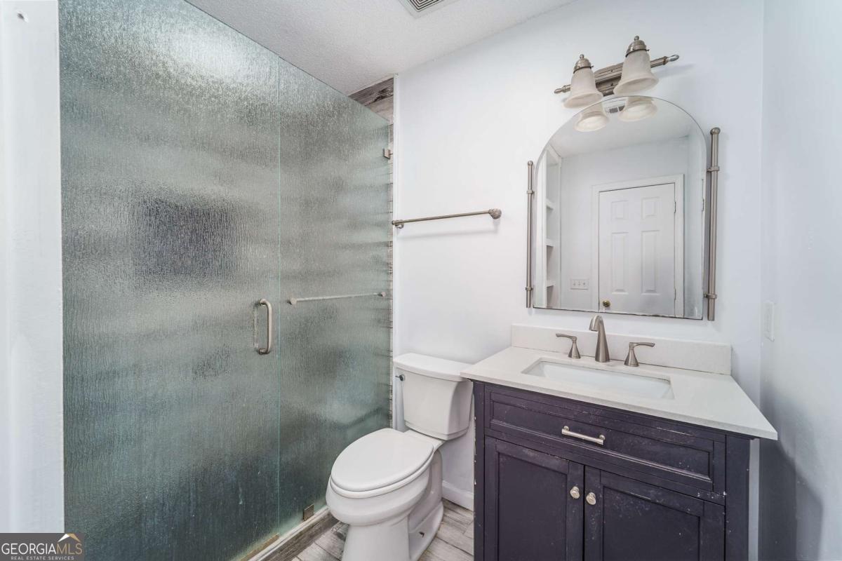 301 Ridge Lane Douglas, GA 31533 - Photo 15 of 26 a bathroom with a sink toilet and shower
