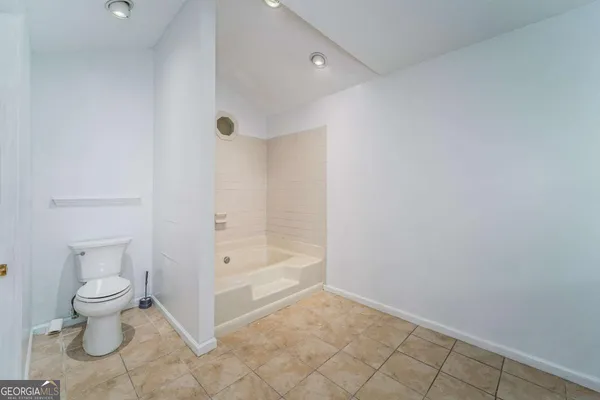 a spacious bathroom with a double vanity sink and a mirror