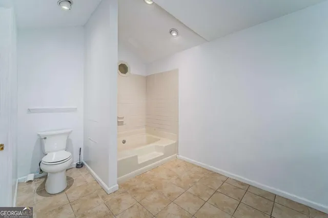 a spacious bathroom with a double vanity sink and a mirror