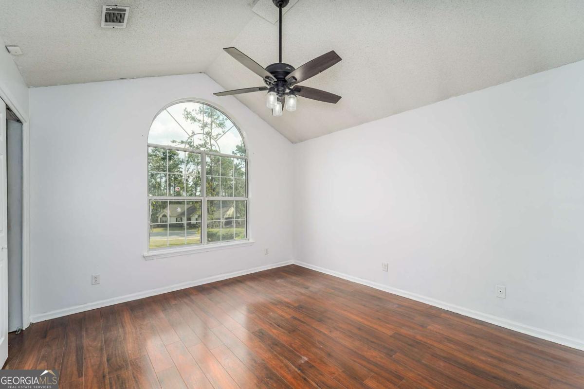301 Ridge Lane Douglas, GA 31533 - Photo 23 of 26 wooden floor in an empty room with a window