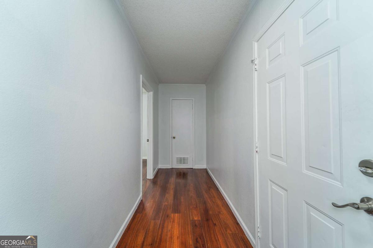 301 Ridge Lane Douglas, GA 31533 - Photo 24 of 26 a view of a hallway with wooden floor and a hallway