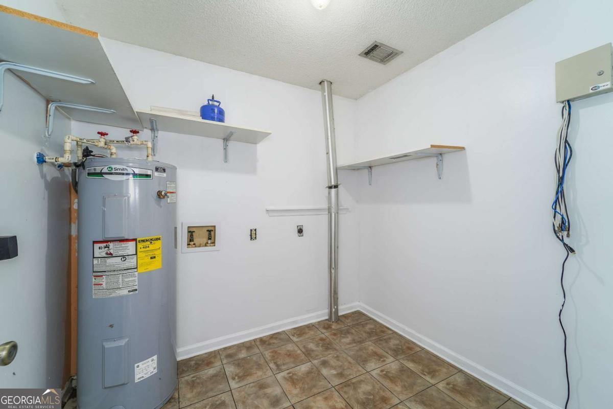 301 Ridge Lane Douglas, GA 31533 - Photo 26 of 26 a view of storage and utility room with washer and dryer