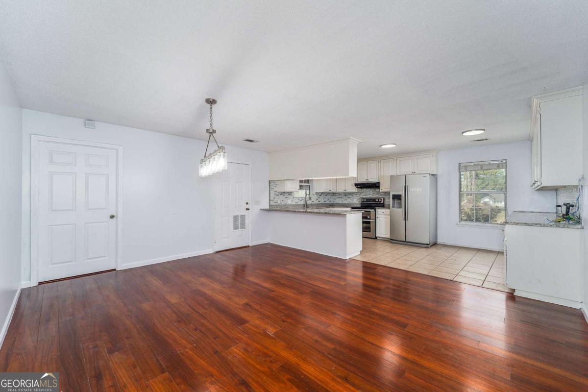 301 Ridge Lane Douglas, GA 31533 - Photo 9 of 26 a view of kitchen with wooden floor and window