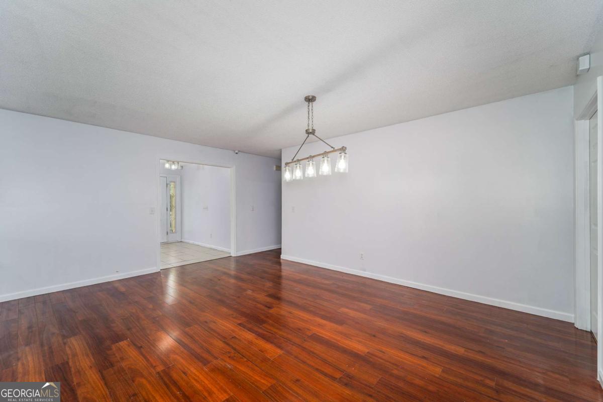 301 Ridge Lane Douglas, GA 31533 - Photo 10 of 26 a view of an empty room with wooden floor