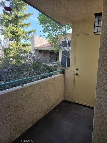 a view of a house with a tree in front of it