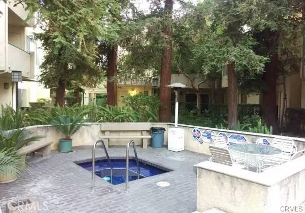 a building outdoor space with patio furniture and potted plants