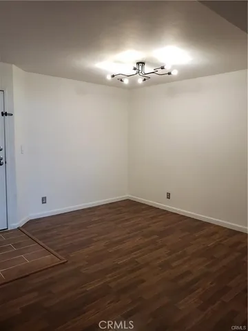 a view of a room with wooden floor