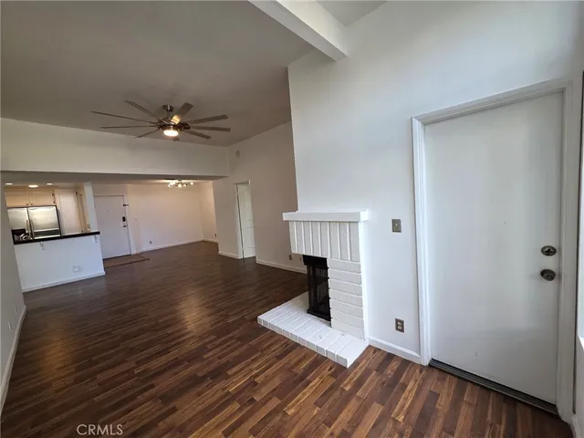 wooden floor in an empty room with a fireplace