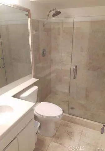 a white toilet next to a bathroom