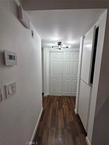a view of a hallway with wooden floor
