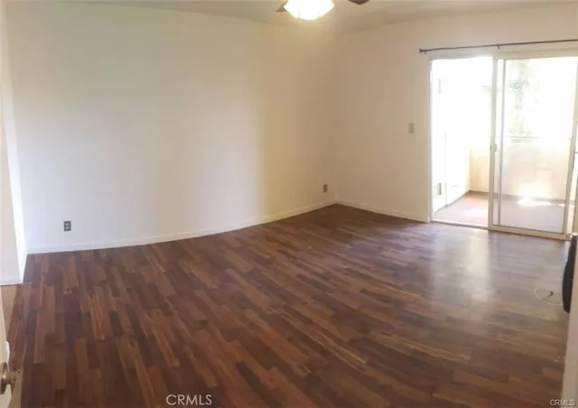 a view of a room with wooden floor and window