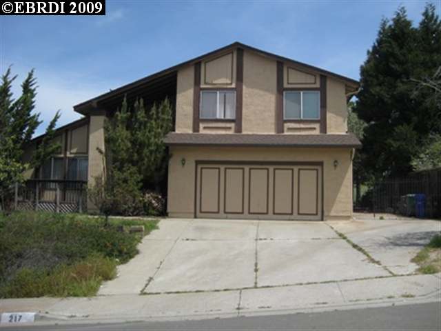 217 Iris Road Hercules, CA 94547 - Photo 1 of 1 a front view of a house with a yard and garage