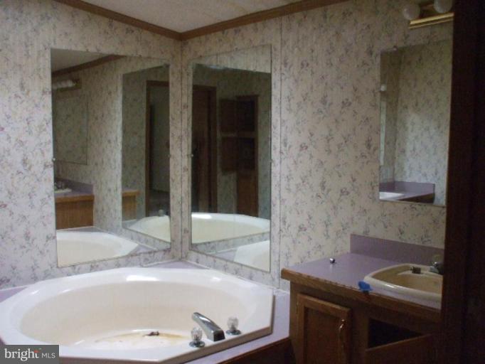 295 Buckler Road Huntingtown, MD 20639 - Photo 7 of 9 a bathroom with a tub