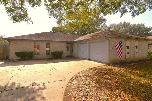 a view of an empty room with a chandelier fan
