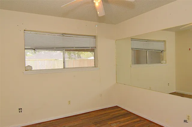 a view of a room with a window and a ceiling fan