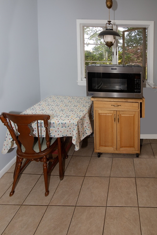 151 West Allen Ridge Road Springfield, MA 01118 - Photo 13 of 30 a kitchen with stainless steel appliances granite countertop a stove a sink and a microwave