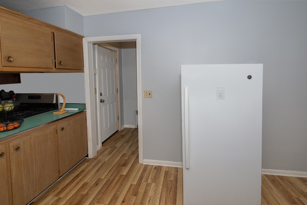 151 West Allen Ridge Road Springfield, MA 01118 - Photo 14 of 30 a kitchen with wooden floor and cabinets