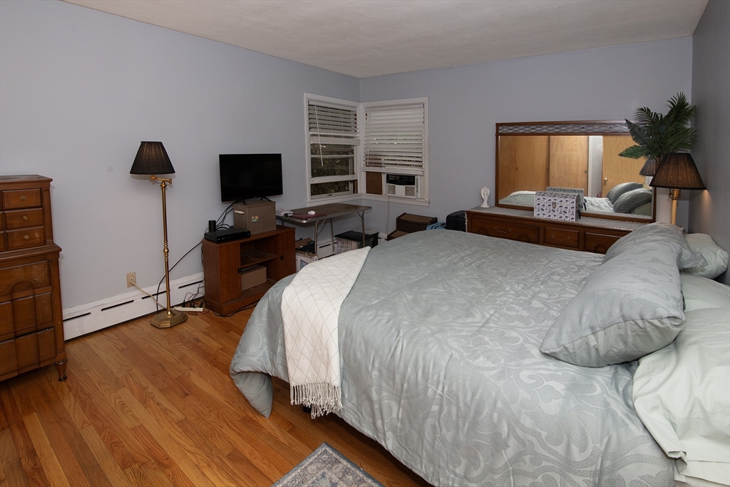 151 West Allen Ridge Road Springfield, MA 01118 - Photo 21 of 30 a bedroom with a bed a couch and a flat screen tv