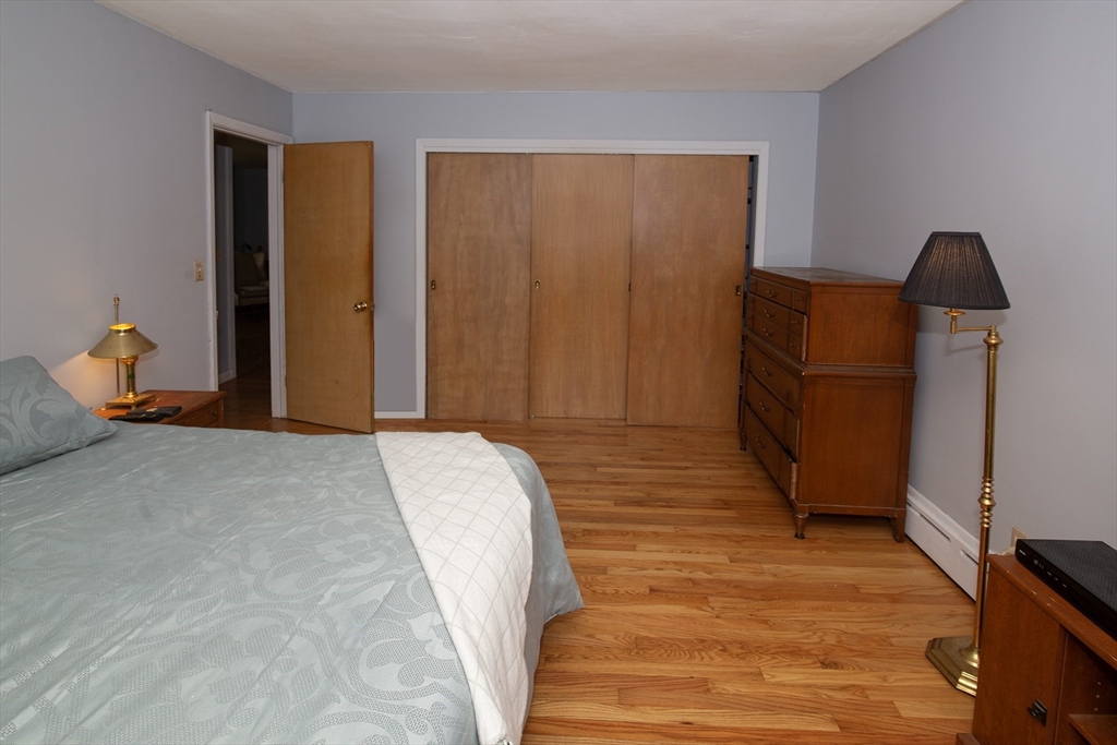 151 West Allen Ridge Road Springfield, MA 01118 - Photo 22 of 30 a bedroom with a bed and wooden floor