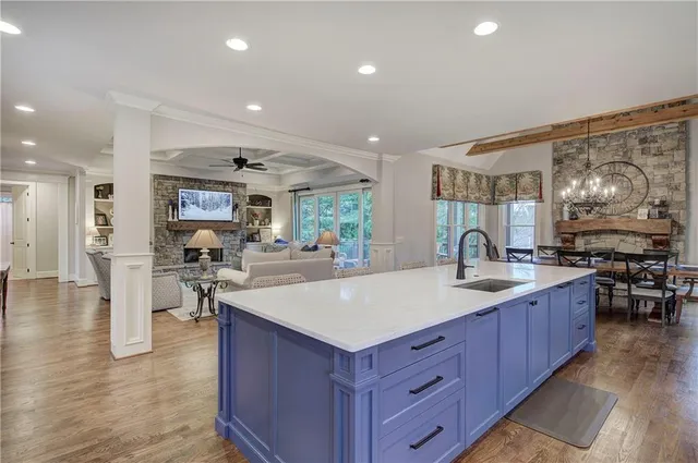 a view of a dining room with furniture a chandelier and wooden floor
