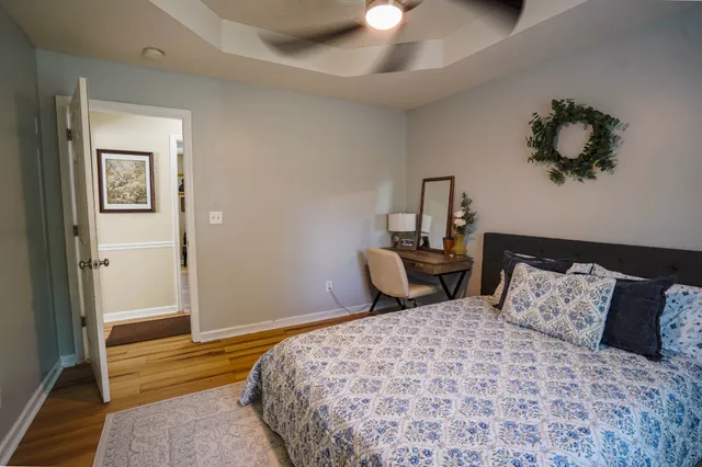 a bedroom with a bed and a painting on the wall