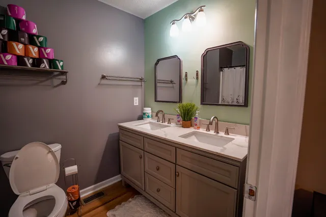 a bathroom with a toilet sink and mirror