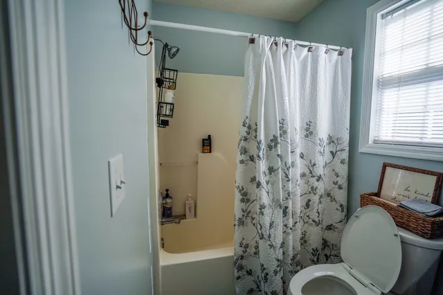 a bathroom with a toilet and shower