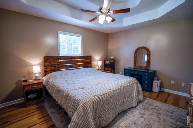 a bedroom with a bed and a chandelier