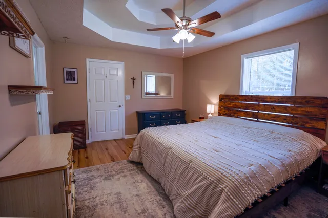 a bedroom with a bed and a chandelier