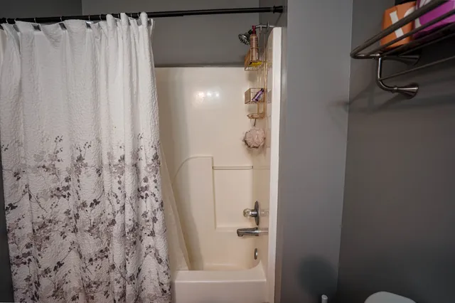 a bathroom with a shower and a tub