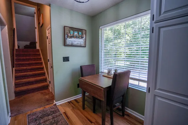 a view of a workspace with furniture and a window