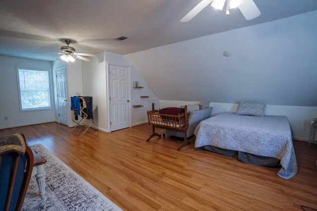 a bedroom with furniture and a wooden floor