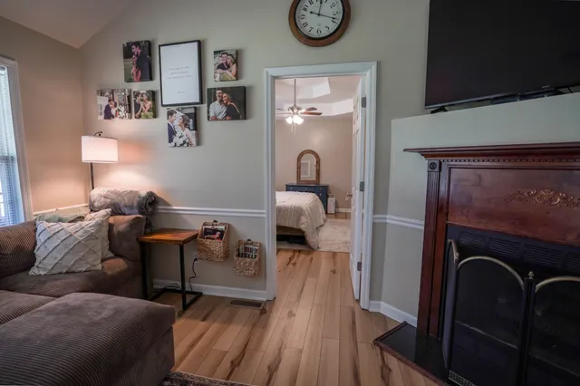 a living room with furniture and a wooden floor