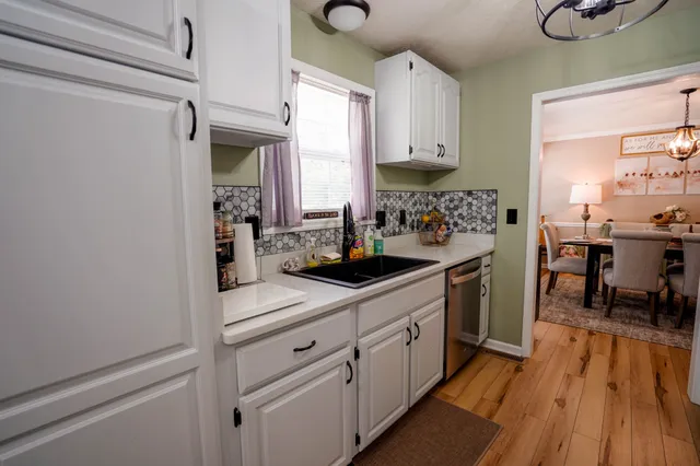 a kitchen with cabinets and window
