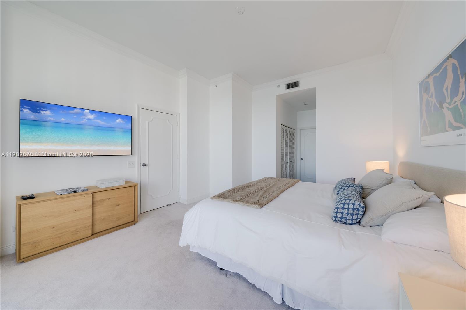 888 Brickell Key Drive, Unit 2610 Miami, FL 33131 - Photo 11 of 37 a bedroom with a bed and a couch