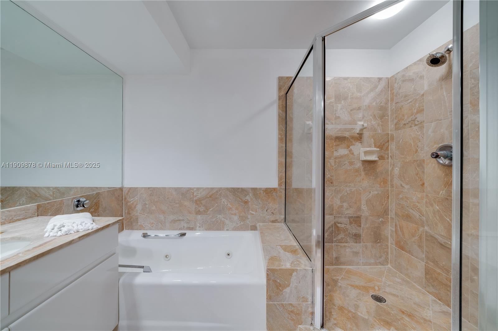 888 Brickell Key Drive, Unit 2610 Miami, FL 33131 - Photo 16 of 37 a bathroom with a bathtub and a shower