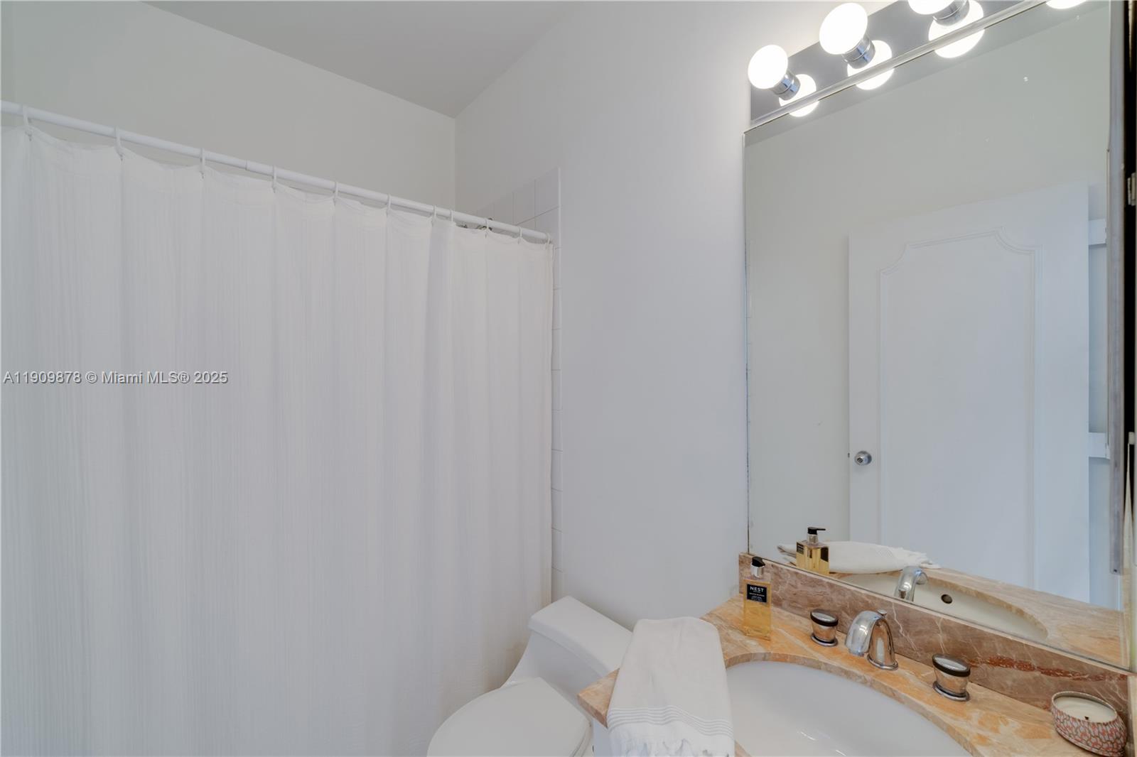 888 Brickell Key Drive, Unit 2610 Miami, FL 33131 - Photo 21 of 37 a bathroom with a sink and a mirror