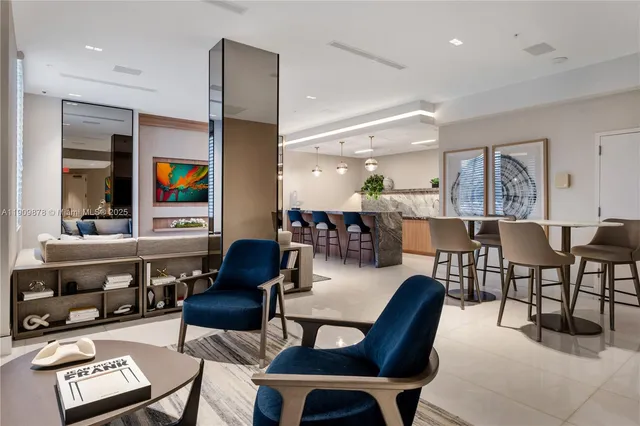 a open kitchen with stainless steel appliances kitchen island granite countertop a table chairs and a view of living room