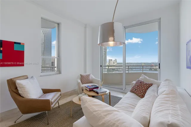 a living room with furniture and a lamp