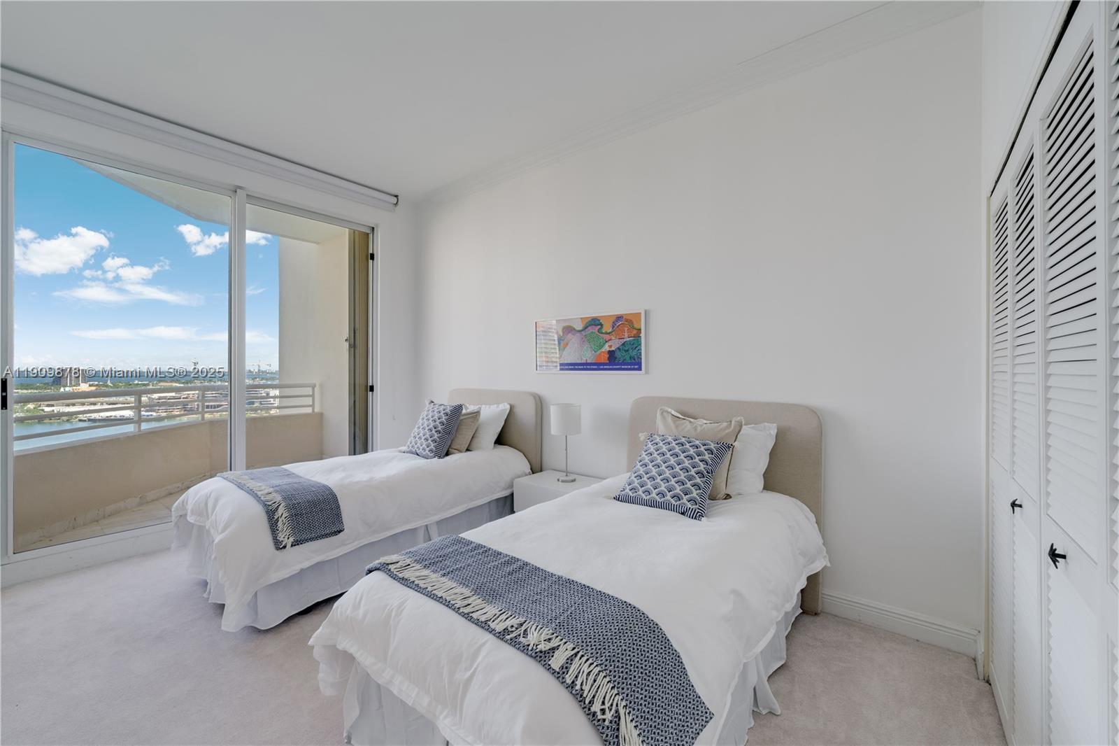 888 Brickell Key Drive, Unit 2610 Miami, FL 33131 - Photo 6 of 37 a bedroom with two large bed and a large window