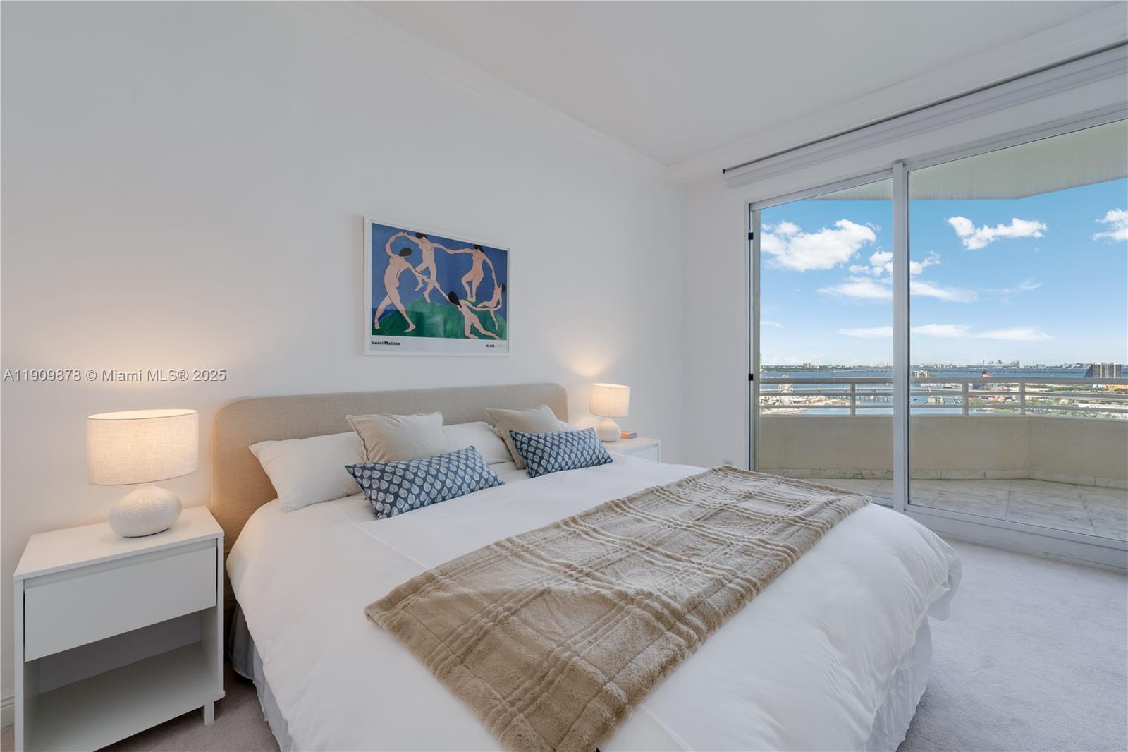 888 Brickell Key Drive, Unit 2610 Miami, FL 33131 - Photo 10 of 37 a bedroom with a large bed and a lamp next to a window