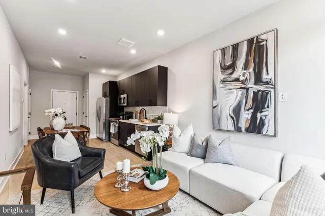 a living room with furniture and a kitchen