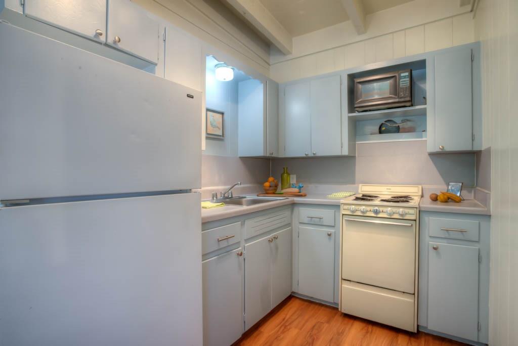 3011 Whitis Avenue, Unit 202 Austin, TX 78705 - Photo 3 of 6 a kitchen with white cabinets and white appliances