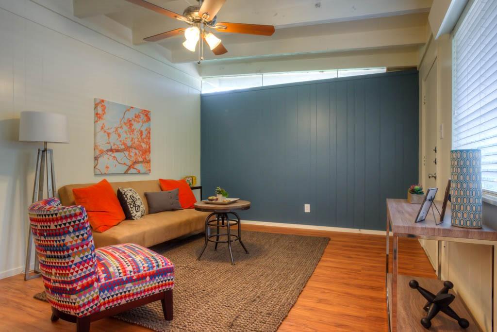 3011 Whitis Avenue, Unit 202 Austin, TX 78705 - Photo 4 of 6 a living room with furniture a rug and a chandelier